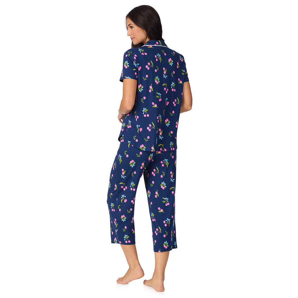 Navy Cherry Bow; Model is wearing size S. She is 5'8.5", Bust 32", Waist 25", Hips 36". @A lady wearing Cotton-Blend Short Sleeve Notch Collar with Cropped Pant 2-Pc Pajama Set in Navy Cherry Bow