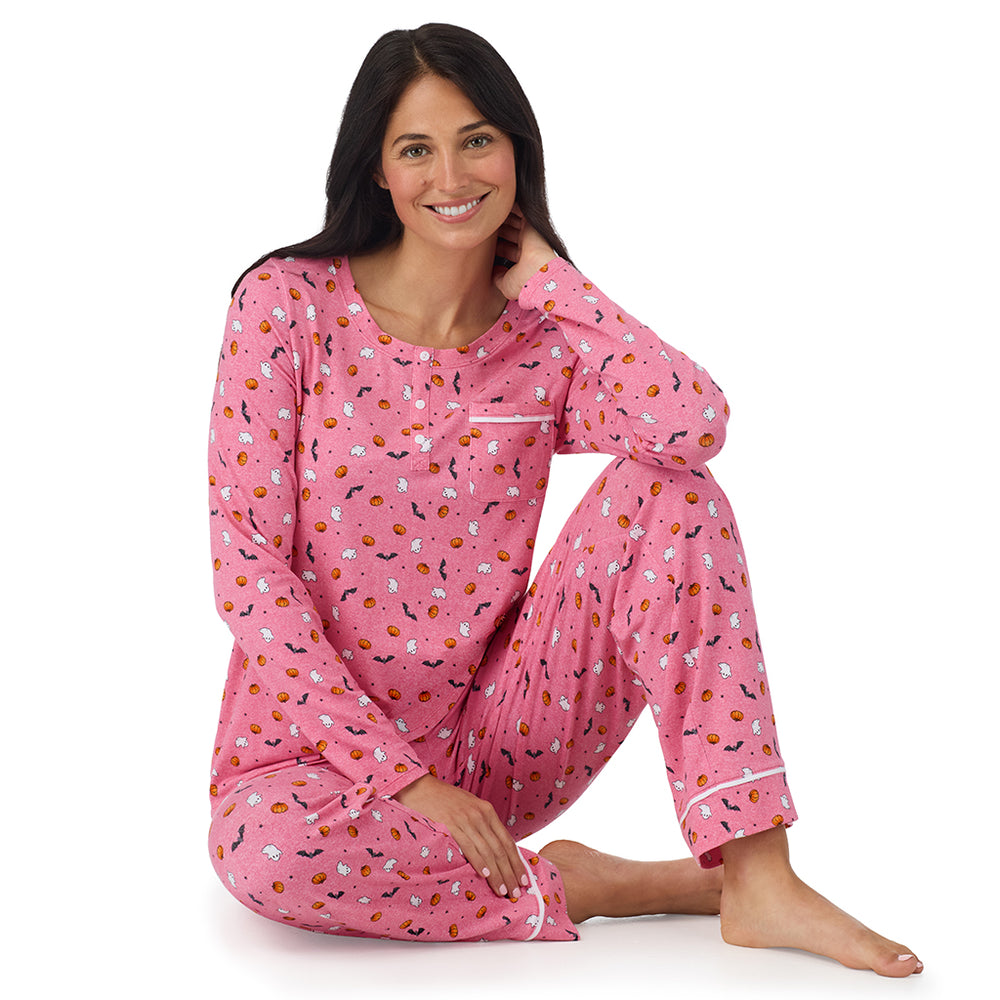 A lady wearing Cotton-Blend Long Sleeve Top and Long Pant Pajama Set in Pink Halloween sitting down