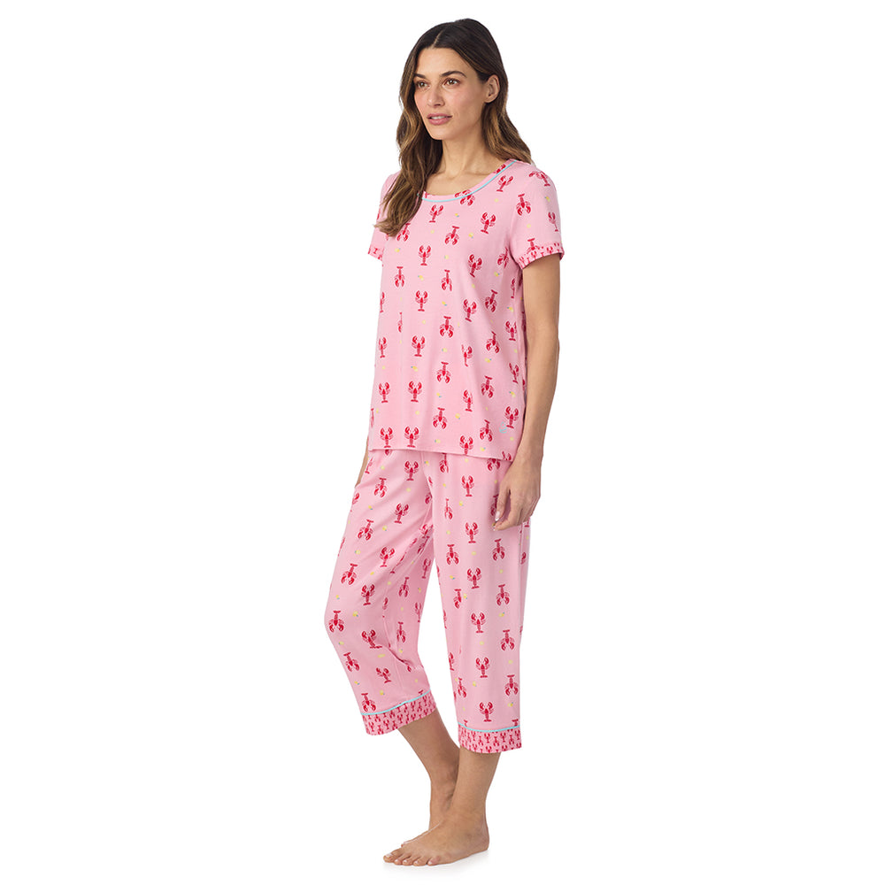 A lady wearing Cotton-Blend Short Sleeve Top and Cropped Pant Pajama Set in Lobster posing side angle view pose