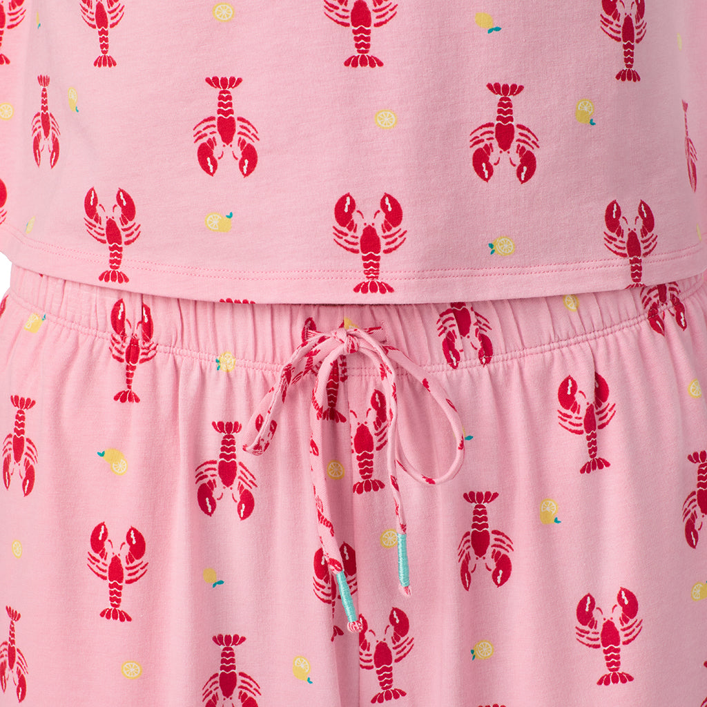  A lady wearing Cotton-Blend Short Sleeve Top and Cropped Pant Pajama Set in Lobster posing close up detail view pose