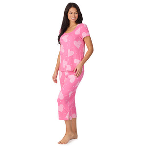 A lady wearing Cotton-Blend Short Sleeve Top with Cropped Pant with Scallop Detail 2-Pc Pajama Set in Ditsy Floral Print