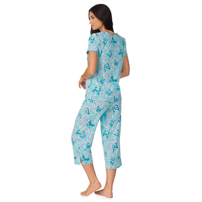 A lady wearing Cotton-Blend Short Sleeve Top with Cropped Pant with Scallop Detail 2-Pc Pajama Set in Aqua Butterfly