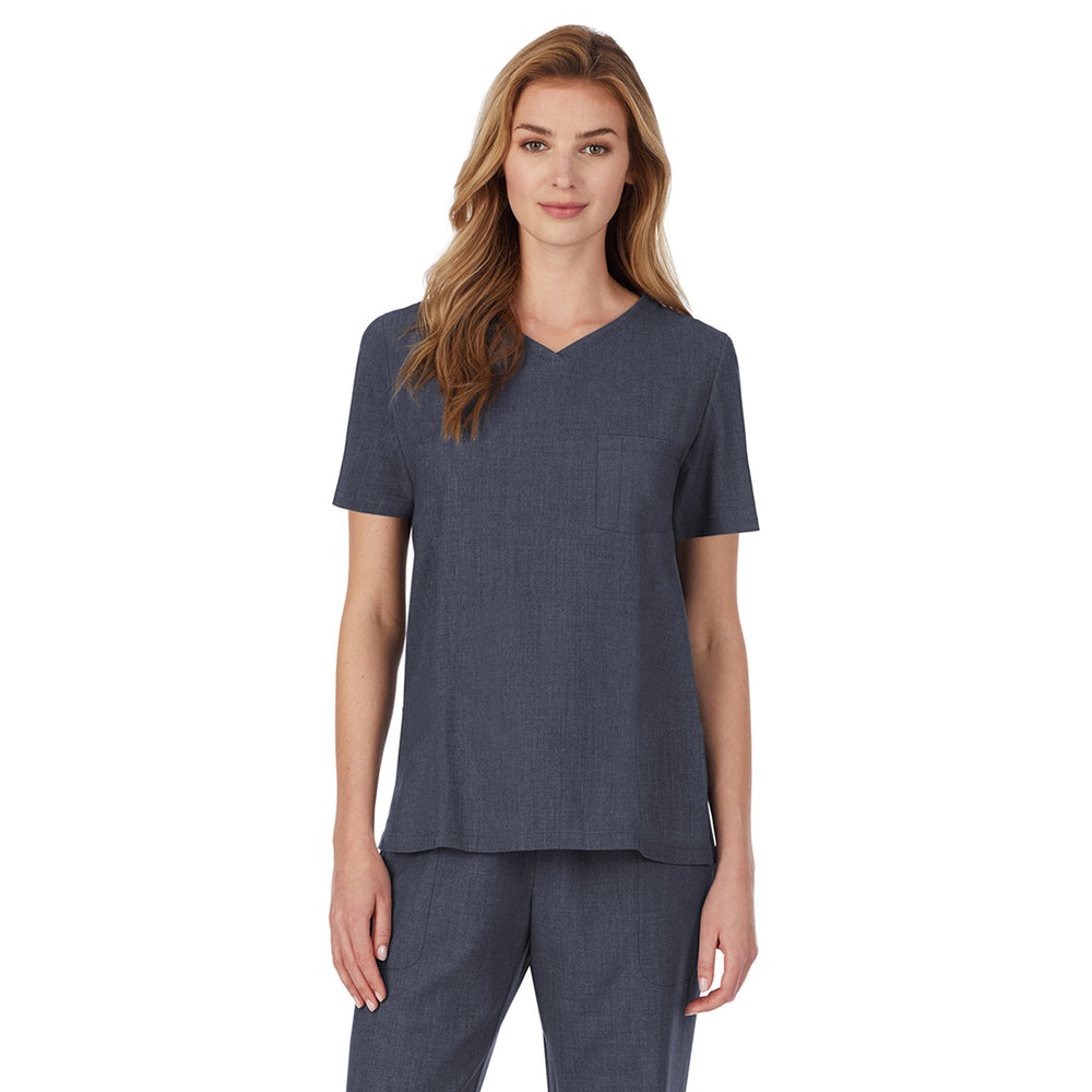 A lady wearing Navy Heather short sleeve scrub v-neck top with chest pocket.