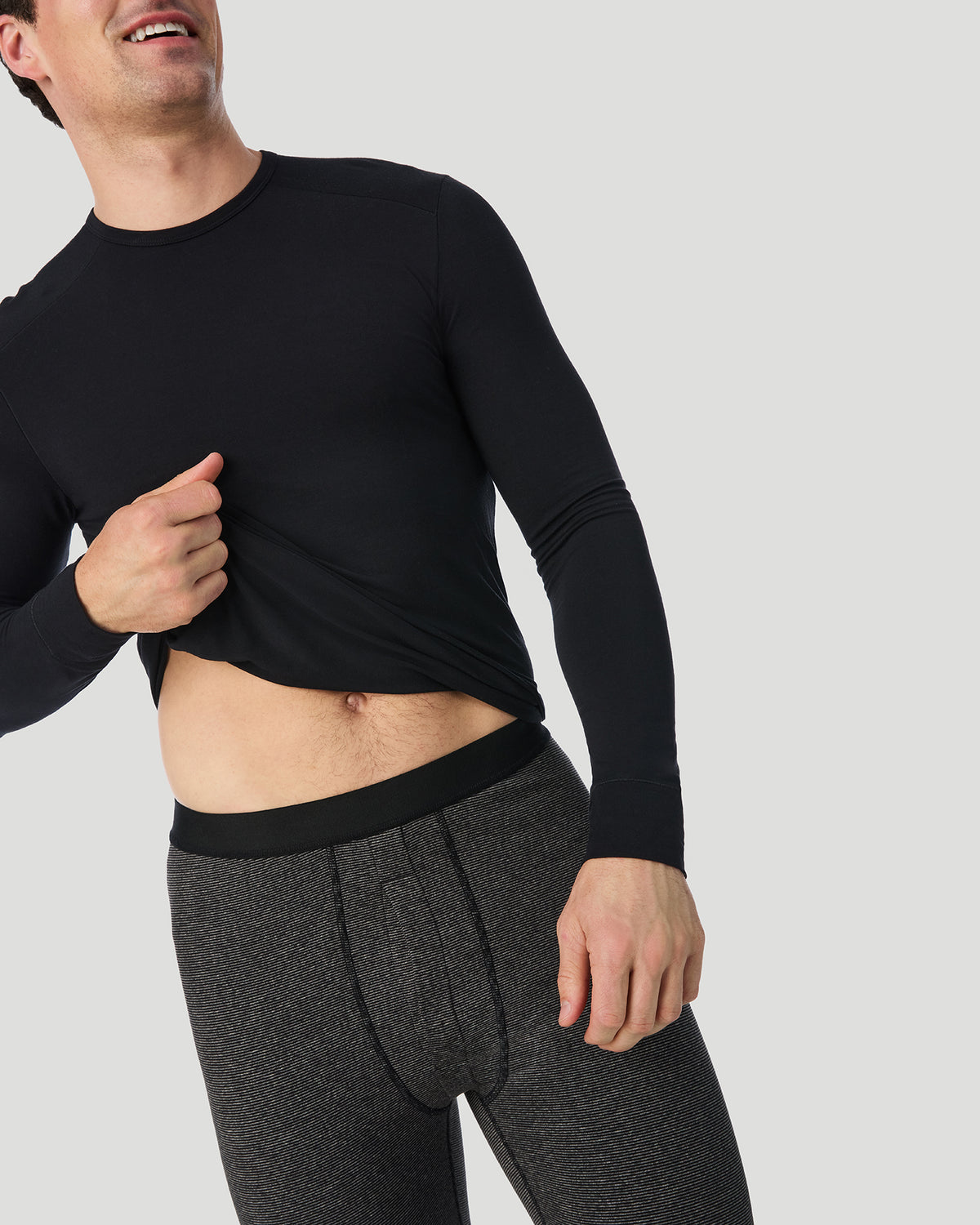  A man wearing Grey Stripe FlexStripe Pant in a front view standing pose while looking to the side