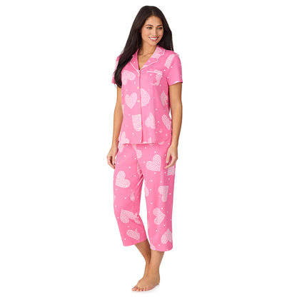A lady wearing Cotton-Blend Short Sleeve Notch Collar with Cropped Pant 2-Pc Pajama Set in Pink Flower Heart