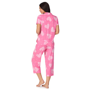 A lady wearing Cotton-Blend Short Sleeve Notch Collar with Cropped Pant 2-Pc Pajama Set in Pink Flower Heart
