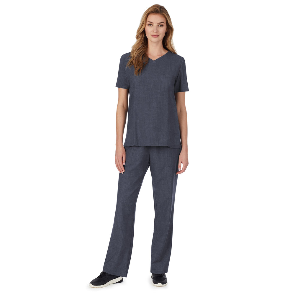 A lady wearing Navy Heather short sleeve scrub v-neck top with chest pocket.