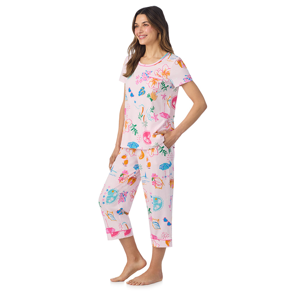 A lady wearing Cotton-Blend Short Sleeve Top and Cropped Pant Pajama Set in Pink Summer Scene posing side angle view pose