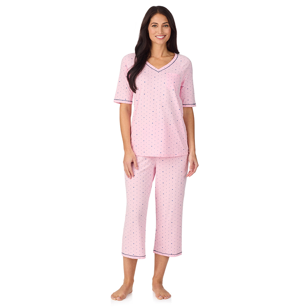 A lady wearing Cuddl Smart Elbow Sleeve Top with Cropped Pant Pajama Set with Pink Bow print