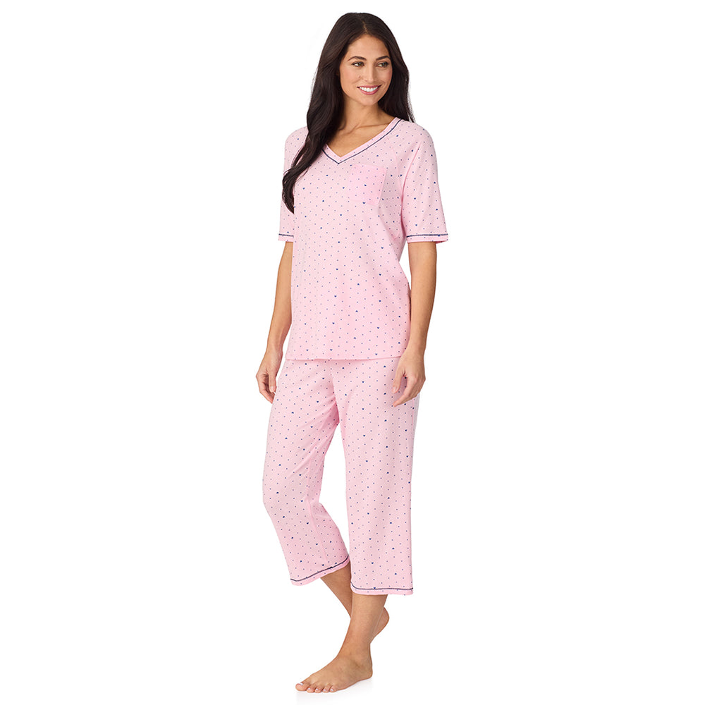 A lady wearing Cuddl Smart Elbow Sleeve Top with Cropped Pant Pajama Set with Pink Bow print
