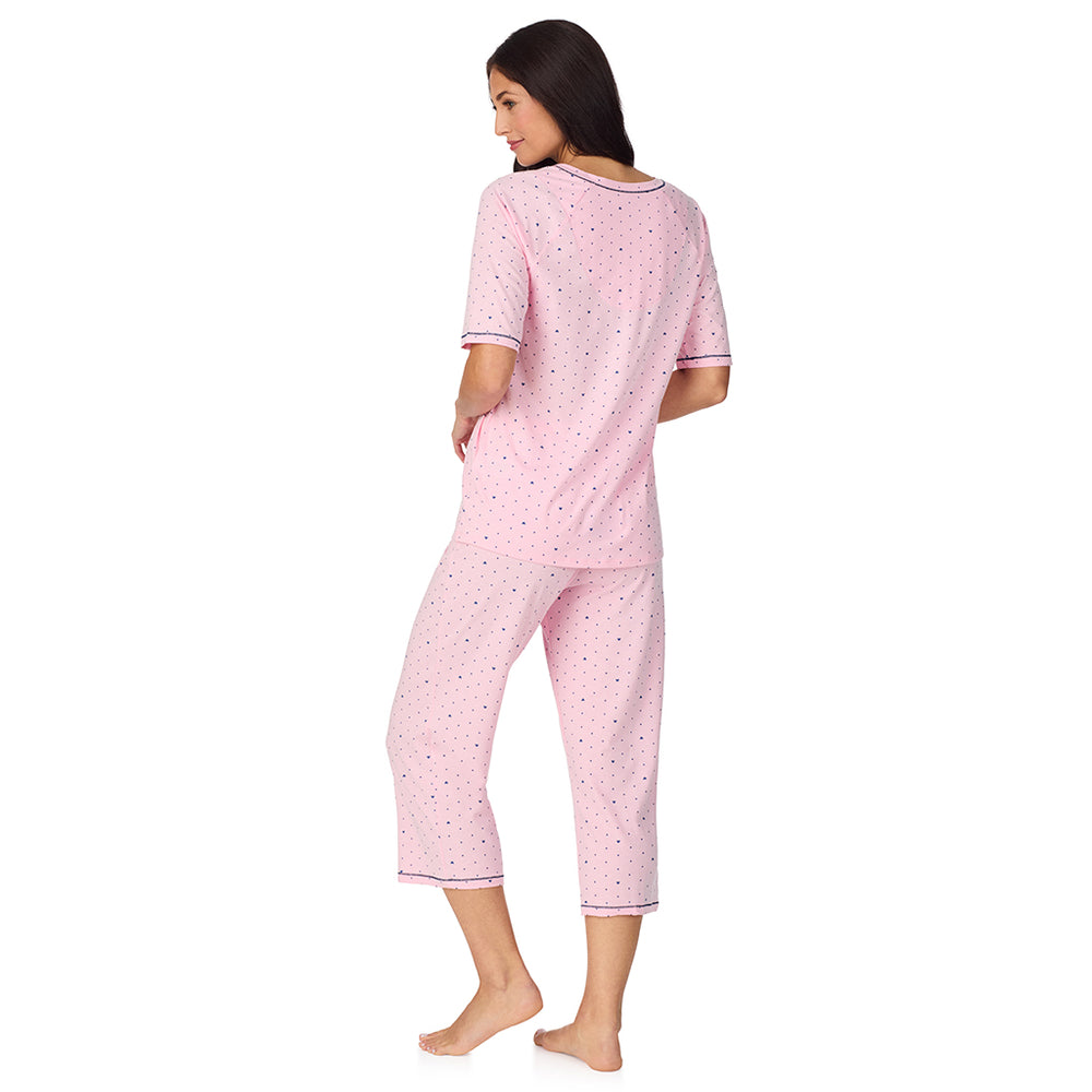 A lady wearing Cuddl Smart Elbow Sleeve Top with Cropped Pant Pajama Set with Pink Bow print