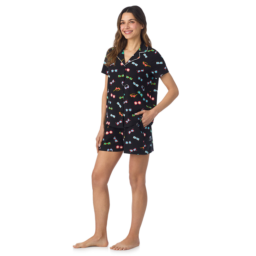 A lady wearing Cotton-Blend Short Sleeve Notch Collar with Short 2-Pc Pajama Set in Black Sunglasses posing side angle view pose with one hand in her pocket