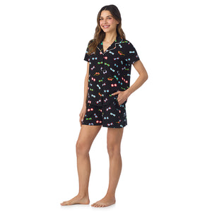  A lady wearing Cotton-Blend Short Sleeve Notch Collar with Short 2-Pc Pajama Set in Black Sunglasses posing side angle view pose with one hand in her pocket