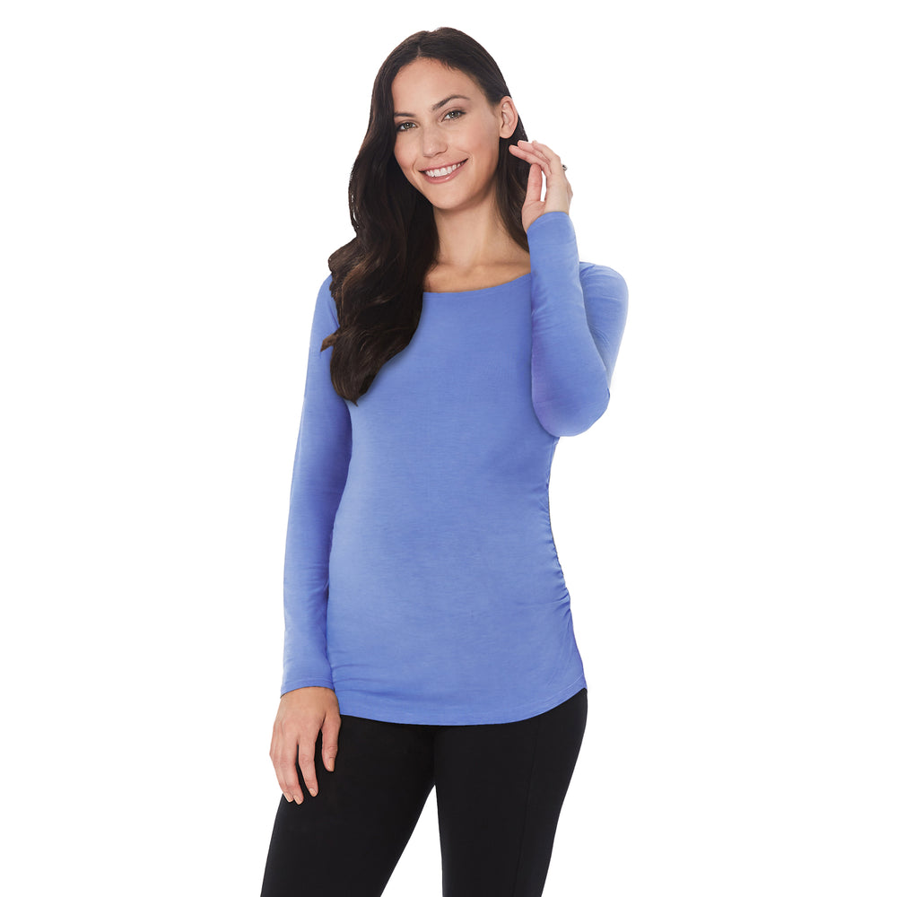 A lady wearing ultramarine long sleeve maternity ballet neck top. #Model is wearing a maternity bump.