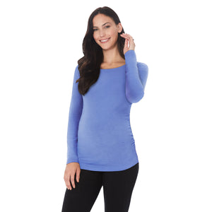 A lady wearing ultramarine long sleeve maternity ballet neck top. #Model is wearing a maternity bump.
