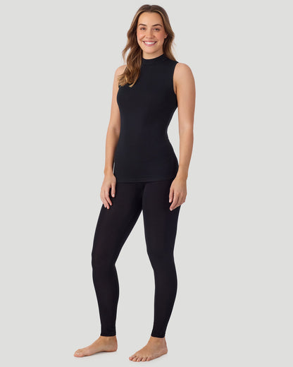 A lady wearing Softwear With Stretch Mock Neck Tank in black shown in a front view standing pose