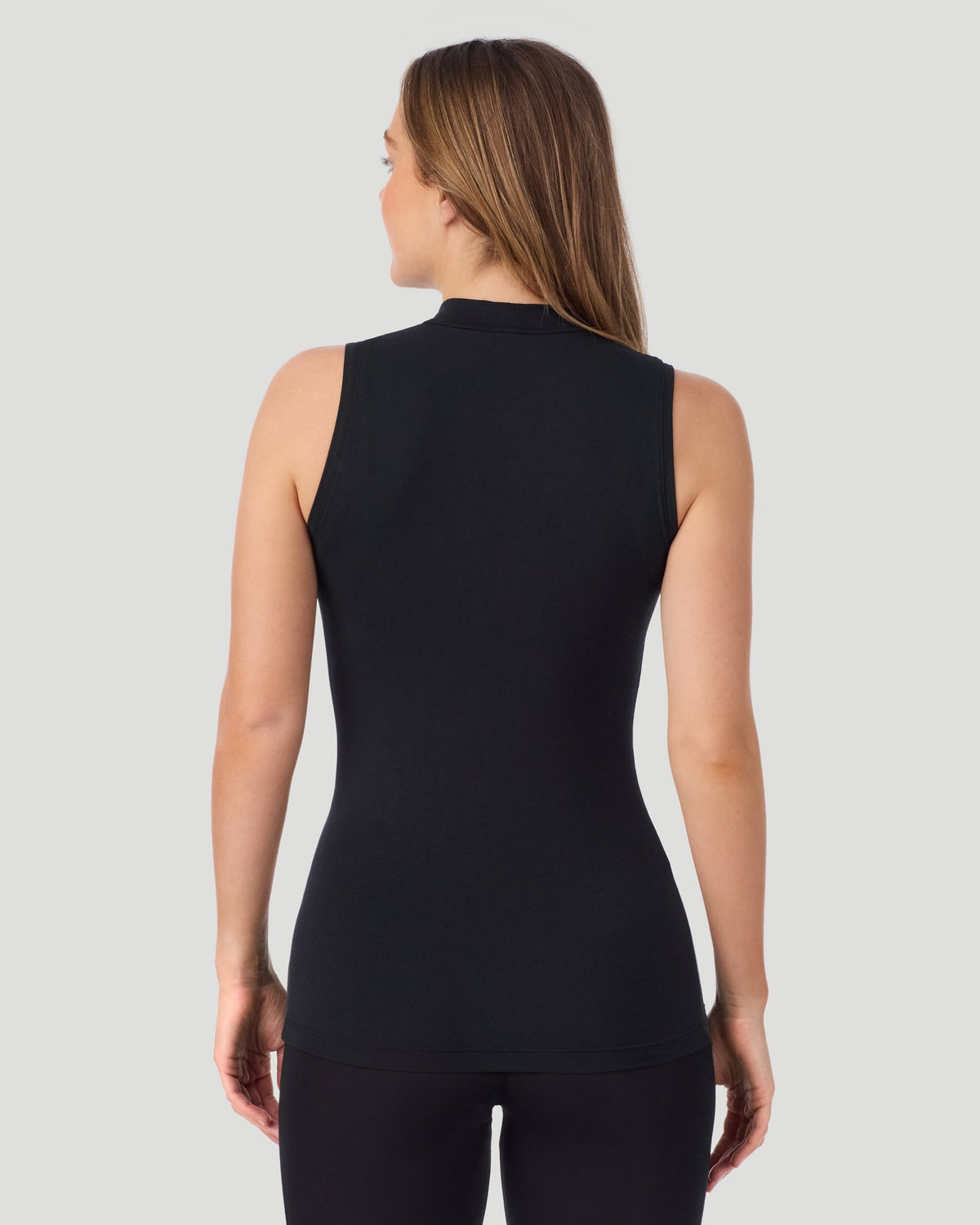 A lady wearing Softwear With Stretch Mock Neck Tank in black shown in a back view pose