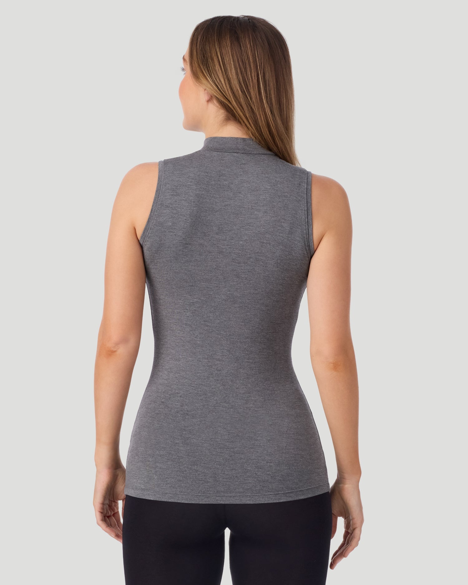 A lady wearing Softwear With Stretch Mock Neck Tank in charcoal heather shown in a back view pose