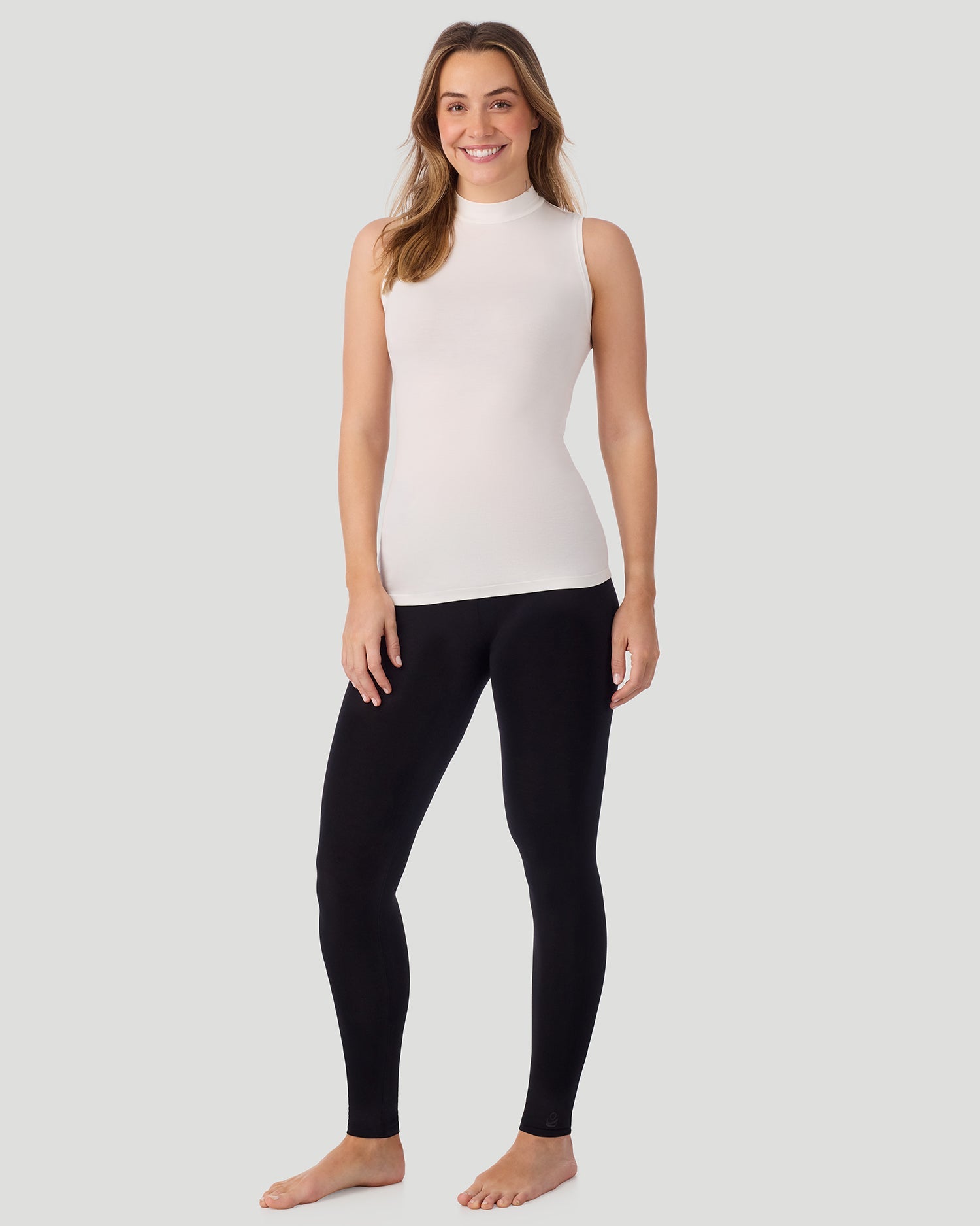 A lady wearing Softwear With Stretch Mock Neck Tank in ivory shown in a front view standing pose