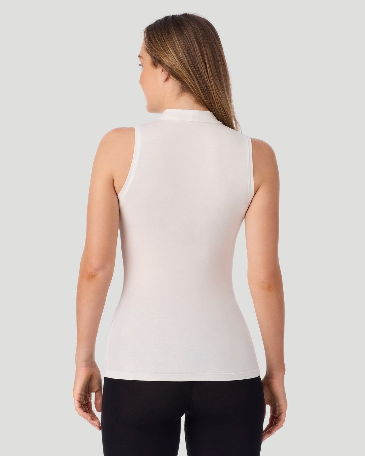 Ivory; Model is wearing size S. She is 5'11.5", Bust 34", Waist 26", Hips 37". @A lady wearing Softwear With Stretch Mock Neck Tank in ivory shown in a back view pose