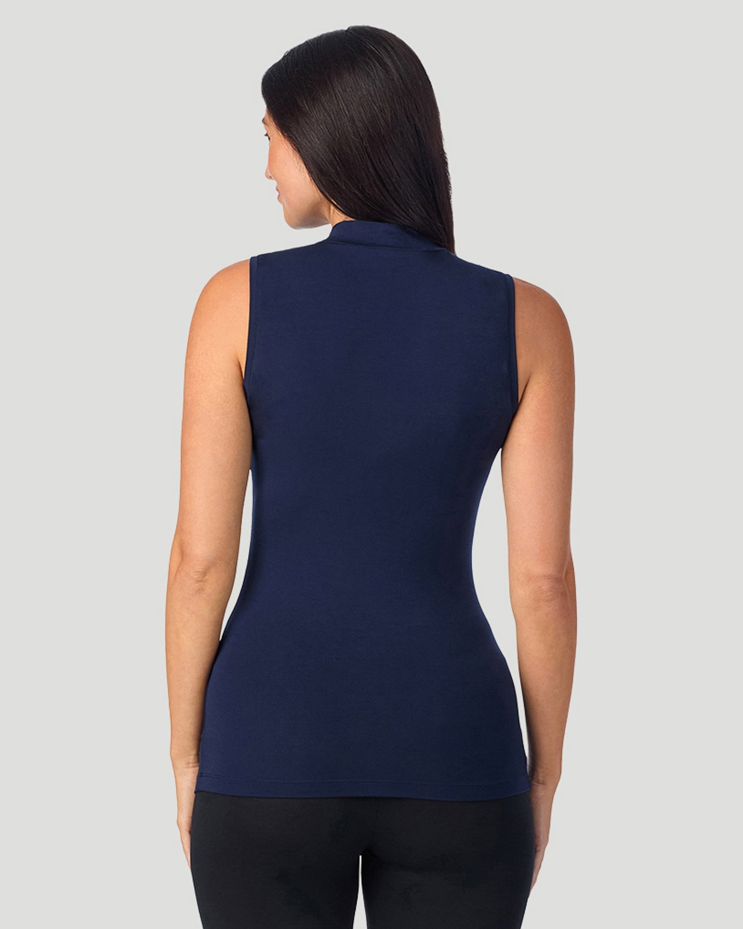 A lady wearing Softwear With Stretch Mock Neck Tank in navy blazer shown in a back view pose