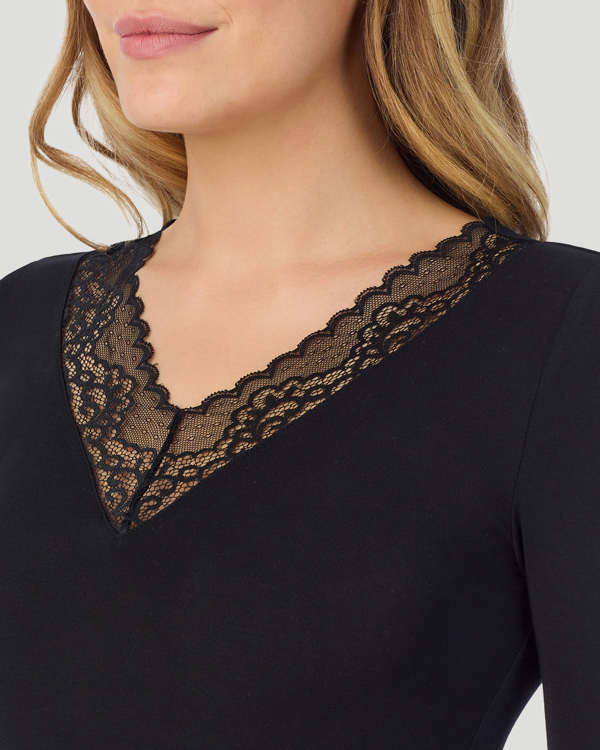 Black; Model is wearing size S. She is 5'11.5", Bust 34", Waist 26", Hips 37". @A lady wearing Softwear With Stretch Long Sleeve V-Neck With Lace in black shown in a front neck close up shot