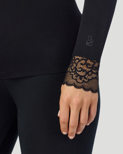 A lady wearing Softwear With Stretch Long Sleeve V-Neck With Lace in black shown in a front view sleeve close up shot