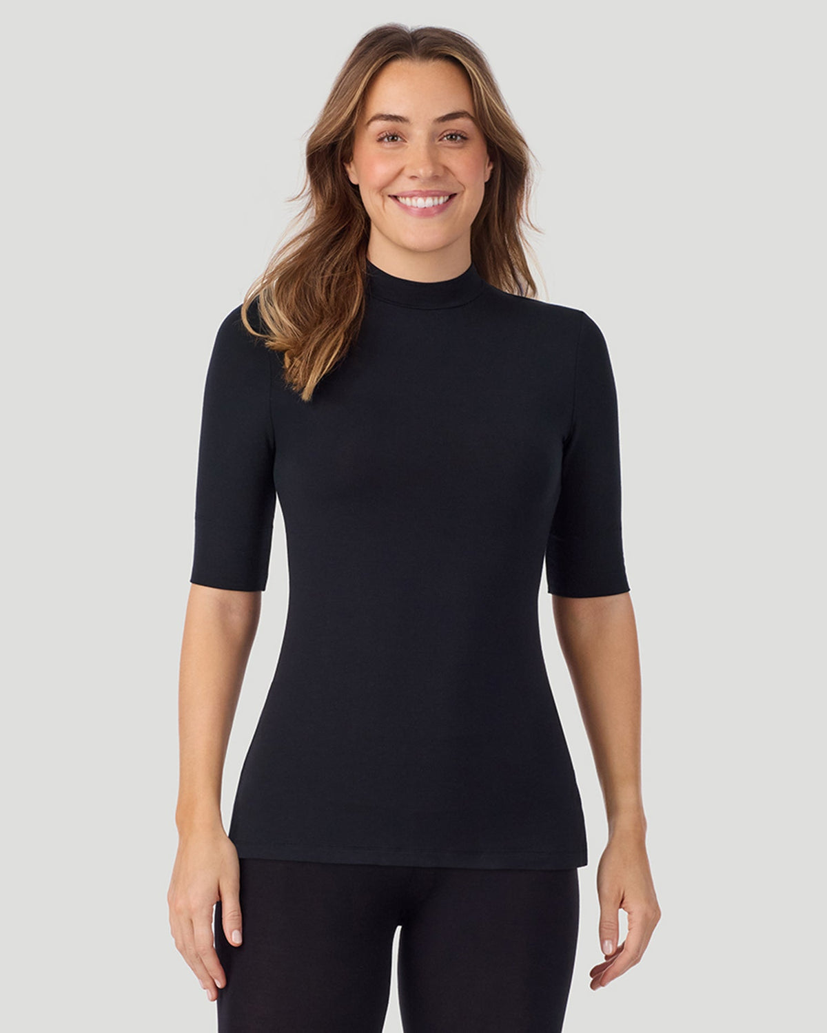 A lady wearing Softwear With Stretch Elbow Sleeve Mock Neck in black shown in a front view pose