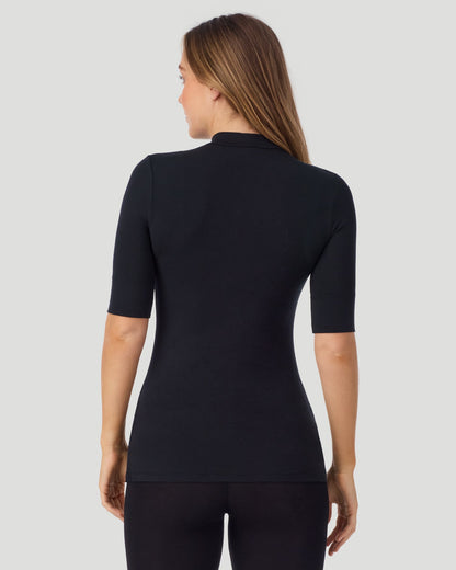 A lady wearing Softwear With Stretch Elbow Sleeve Mock Neck in black shown in a back view pose