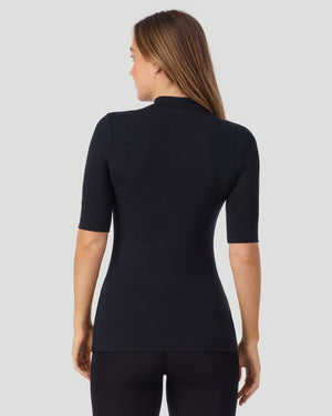 A lady wearing Softwear With Stretch Elbow Sleeve Mock Neck in black shown in a back view pose