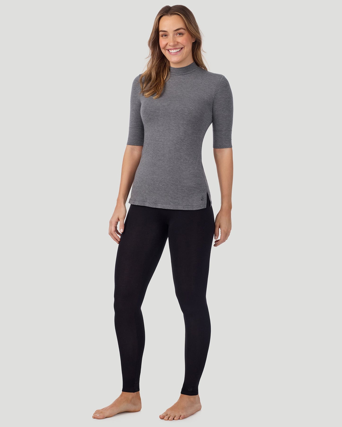 Charcoal Heather; Model is wearing size S. She is 5'11.5", Bust 34", Waist 26", Hips 37". @A lady wearing Softwear With Stretch Elbow Sleeve Mock Neck in charcoal heather shown in a front view standing pose
