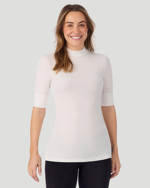 A lady wearing Softwear With Stretch Elbow Sleeve Mock Neck in ivory shown in a front view pose