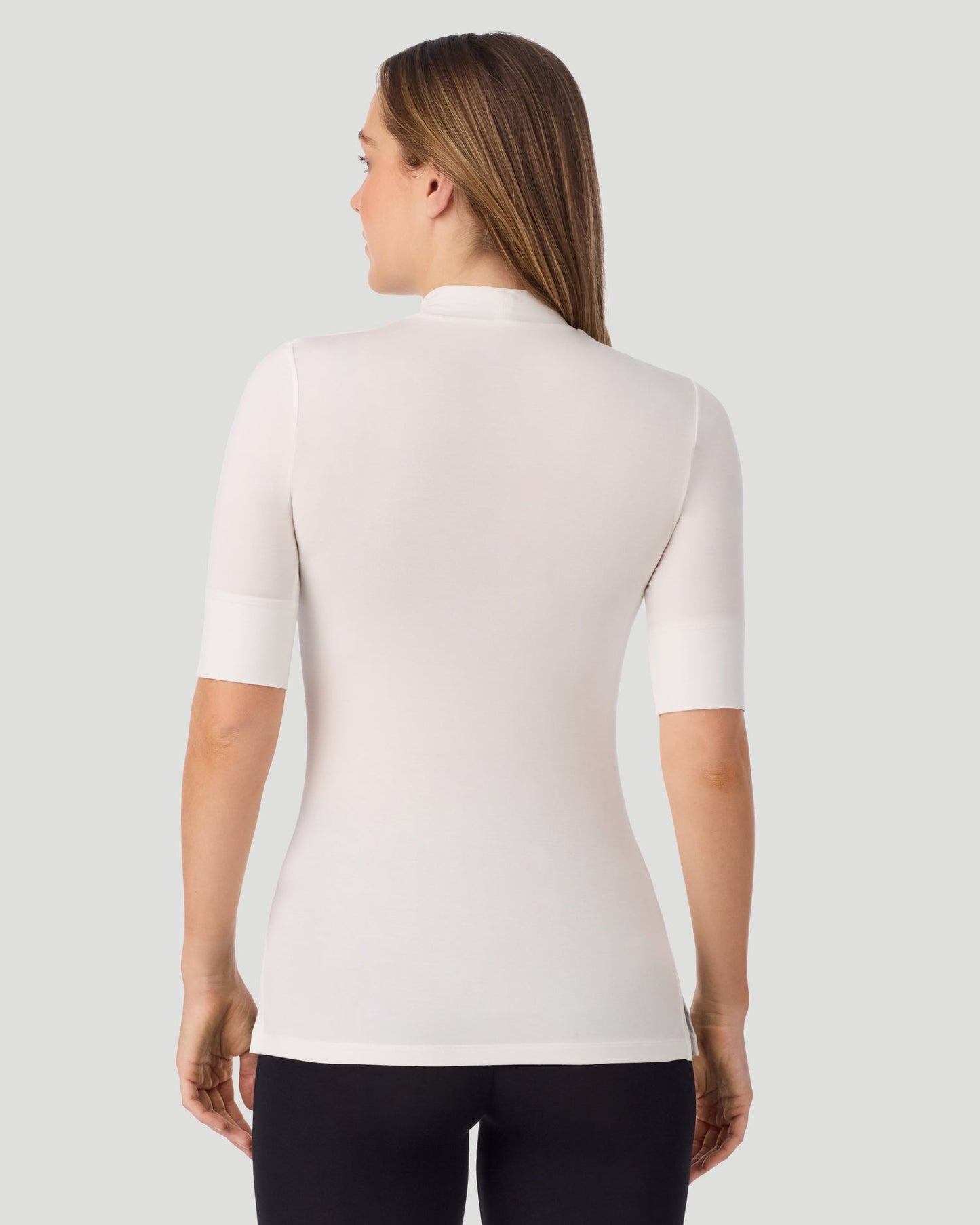 Ivory; Model is wearing size S. She is 5'11.5", Bust 34", Waist 26", Hips 37". @A lady wearing Softwear With Stretch Elbow Sleeve Mock Neck in ivory shown in a back view pose