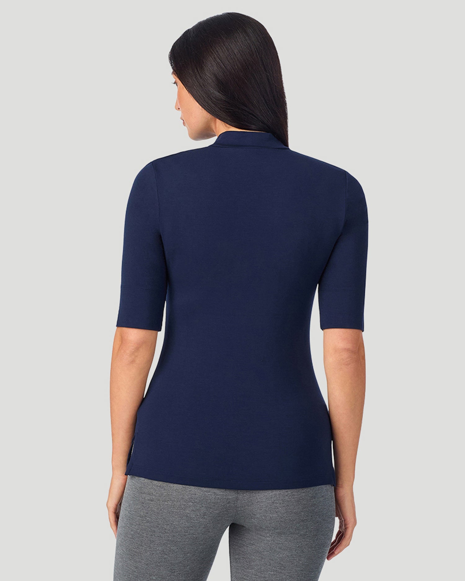 A lady wearing Softwear With Stretch Elbow Sleeve Mock Neck in navy blazer shown in a back view pose