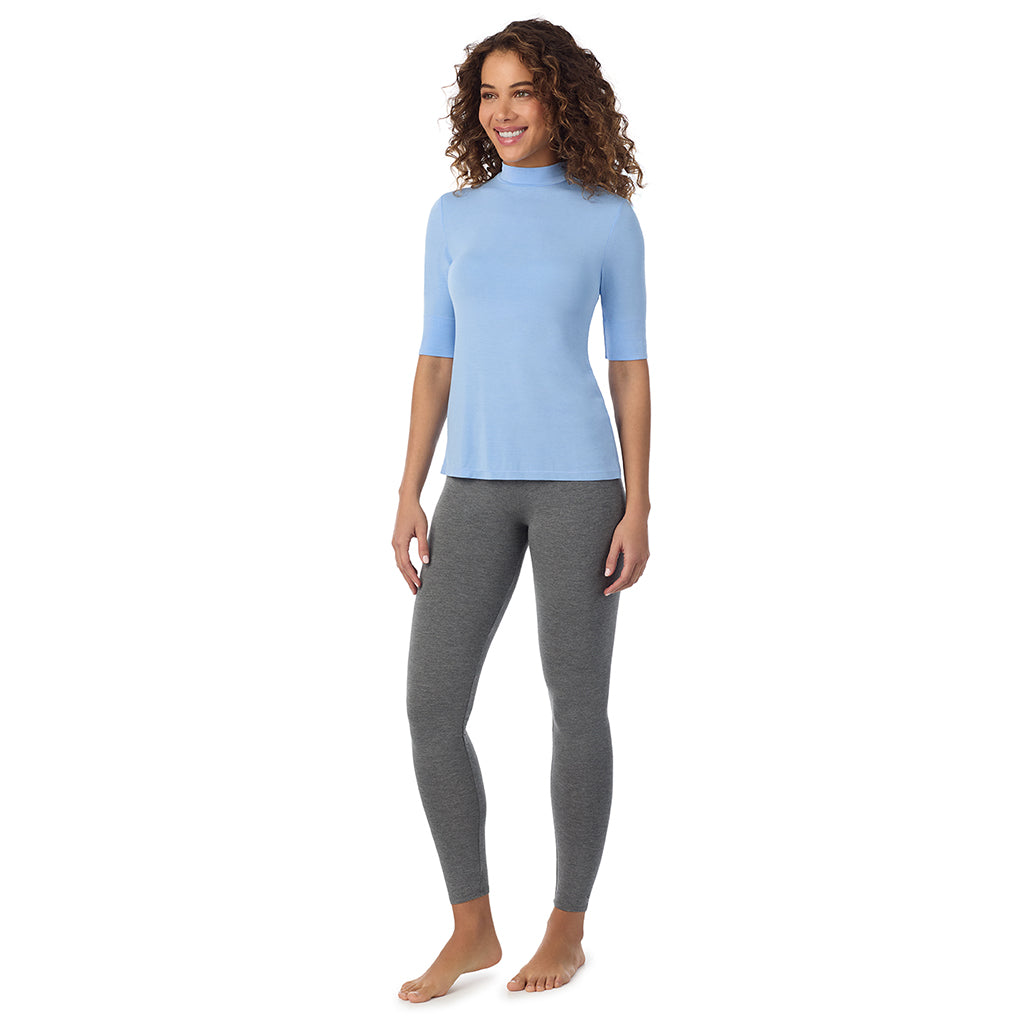 A lady wearing a vista blue elbow sleeve mock neck.