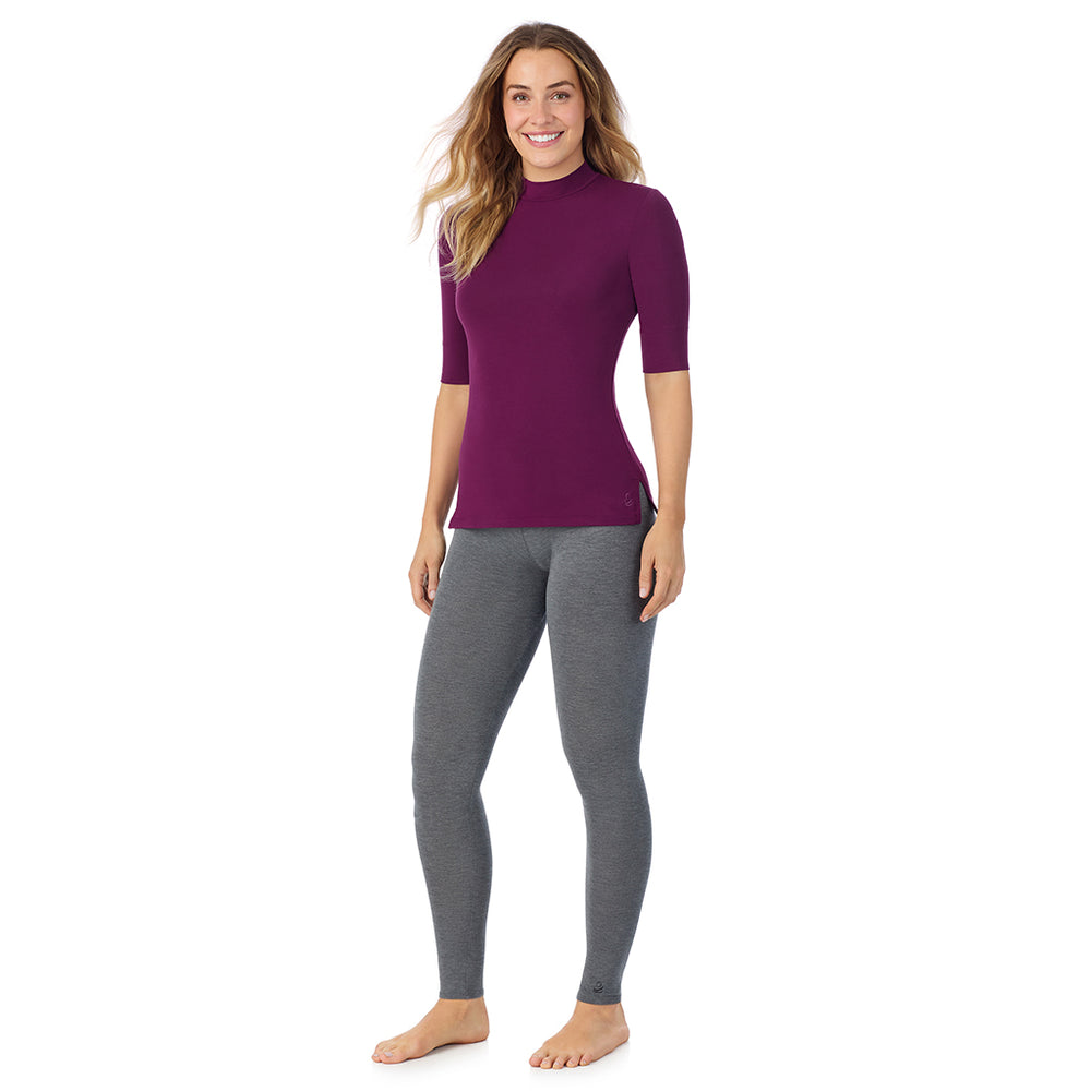 A lady wearing a dark purple elbow sleeve mock neck.