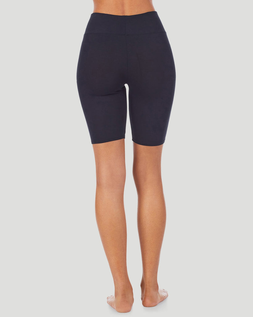 A lady wearing Softwear With Stretch Short in black shown in a back view pose