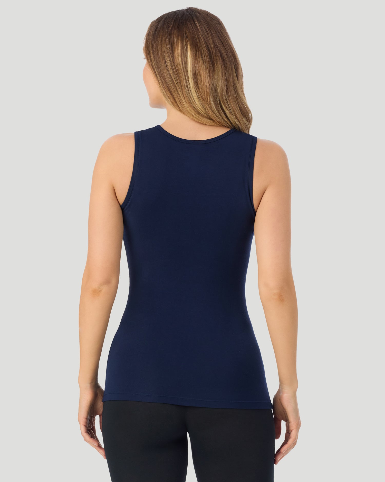 A lady wearing Softwear With Stretch Crew Neck Tank With Lace in navy blazer shown in a back view pose