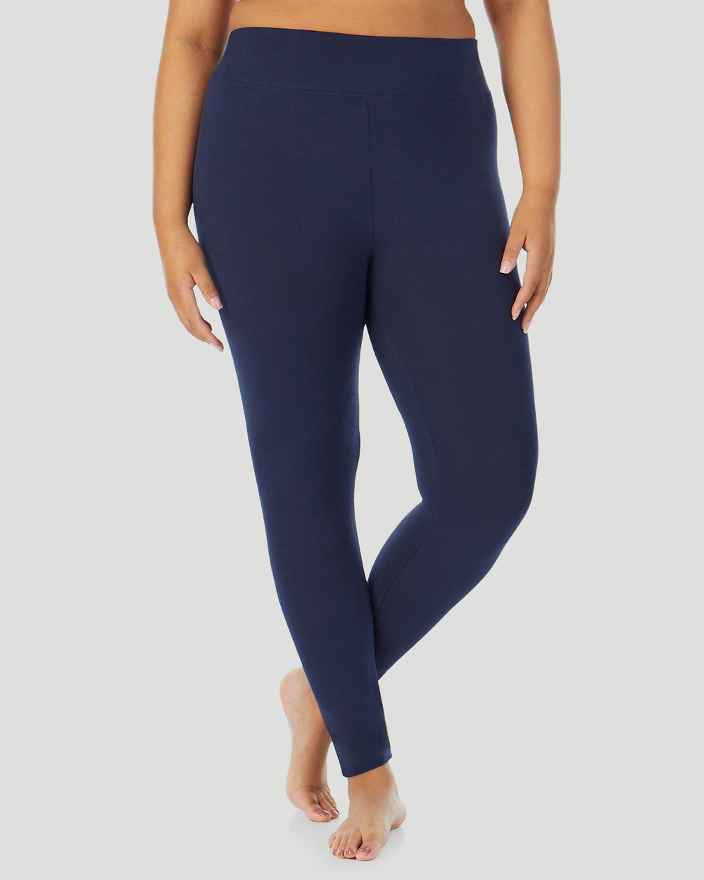 A plus size lady wearing Softwear With Stretch High Waist Legging PLUS in navy blazer in a front view side angle pose
