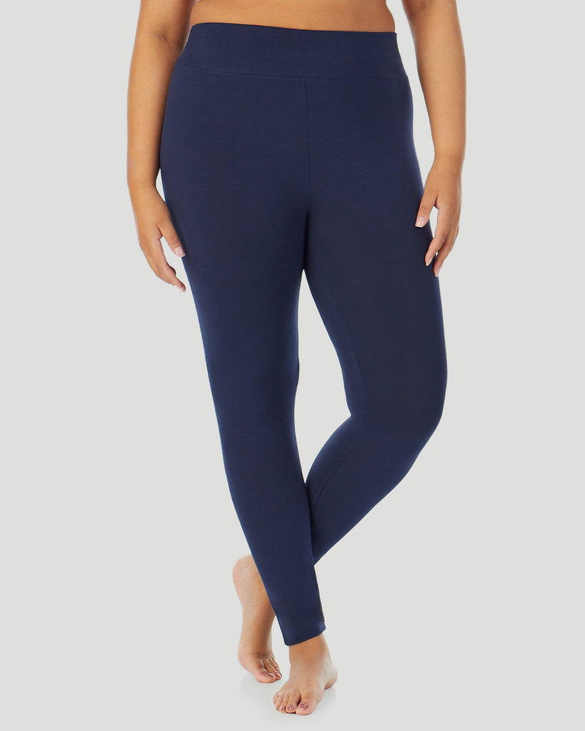 A plus size lady wearing Softwear With Stretch High Waist Legging PLUS in navy blazer in a front view side angle pose 