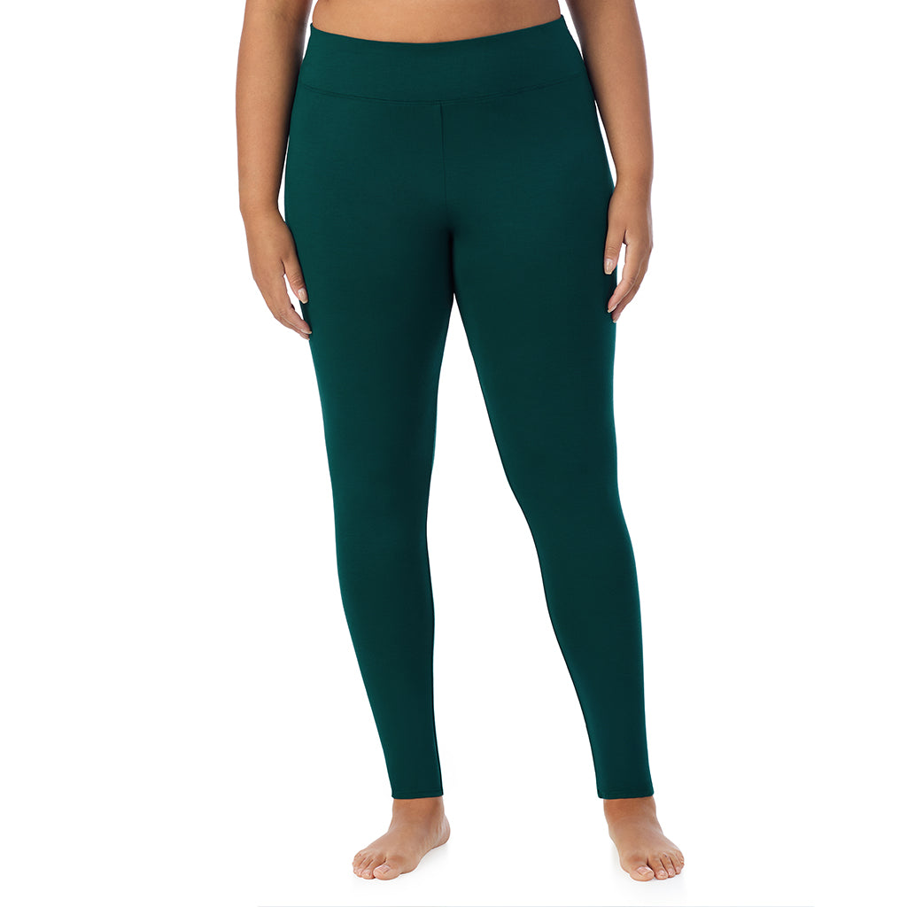 A lady wearing a dark pine high waist legging plus.