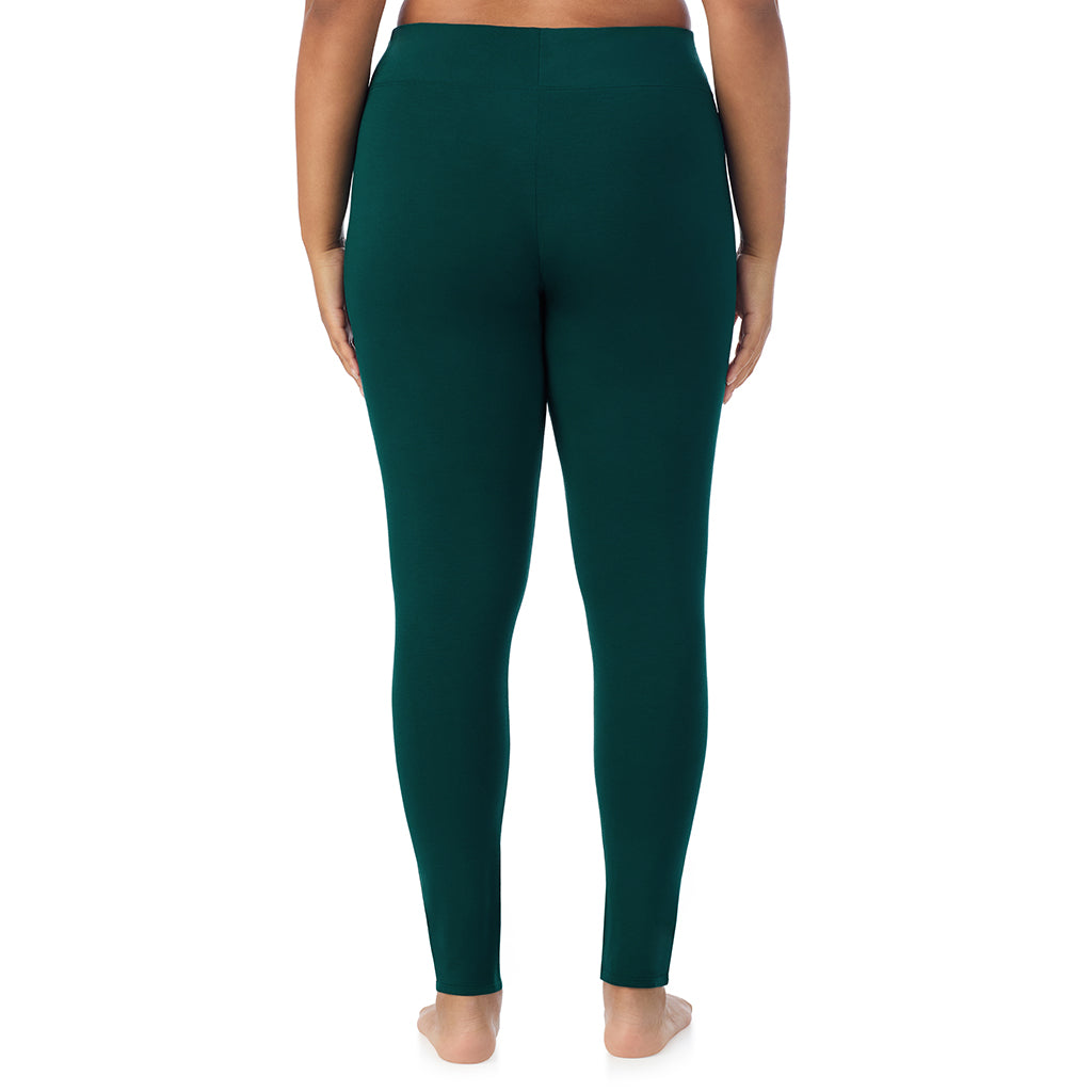 A lady wearing a dark pine high waist legging plus.