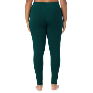 A lady wearing a dark pine high waist legging plus.