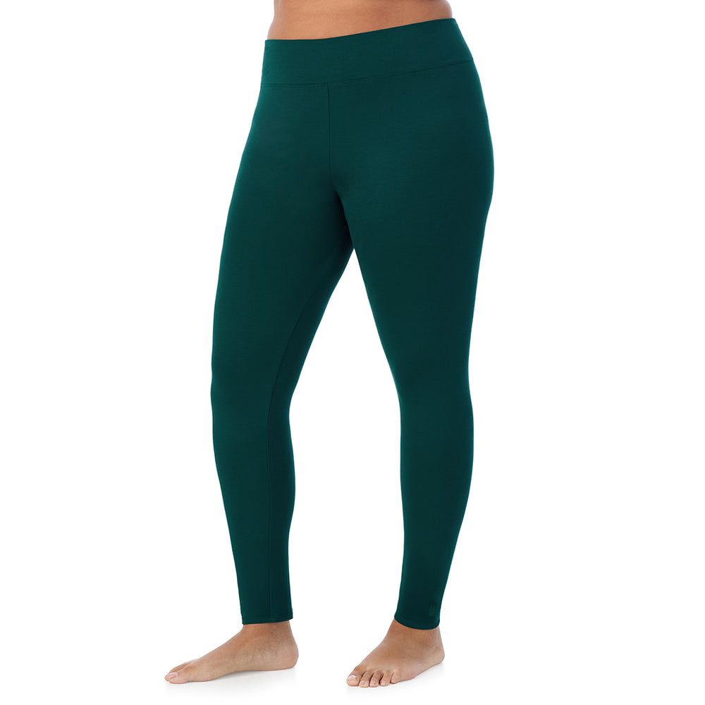 A lady wearing a dark pine high waist legging plus.