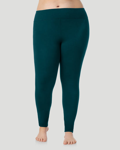 A plus size lady wearing Softwear With Stretch High Waist Legging PLUS in deep emerald in a front view pose