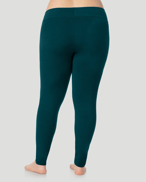 A plus size lady wearing Softwear With Stretch High Waist Legging PLUS in deep emerald in a back view pose