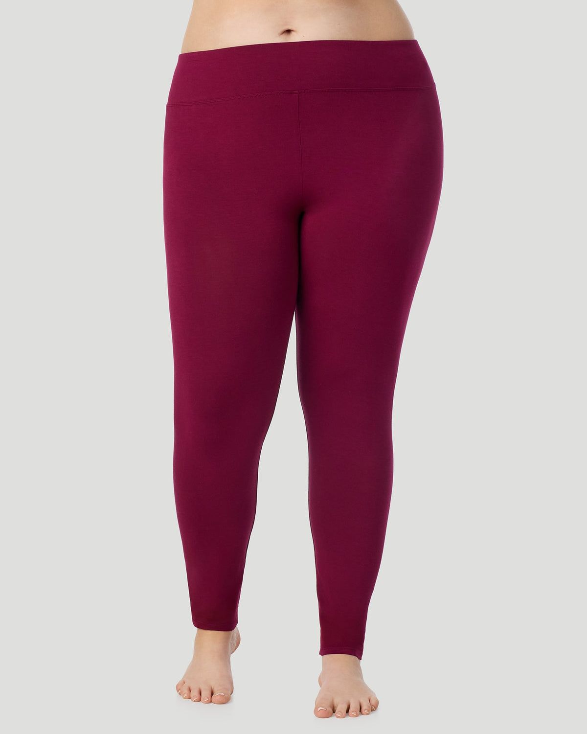 A plus size lady wearing Softwear With Stretch High Waist Legging PLUS in scarlet in a front view pose