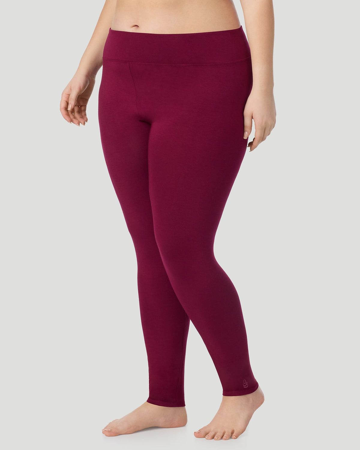 A plus size lady wearing Softwear With Stretch High Waist Legging PLUS in scarlet in a front view side angle pose