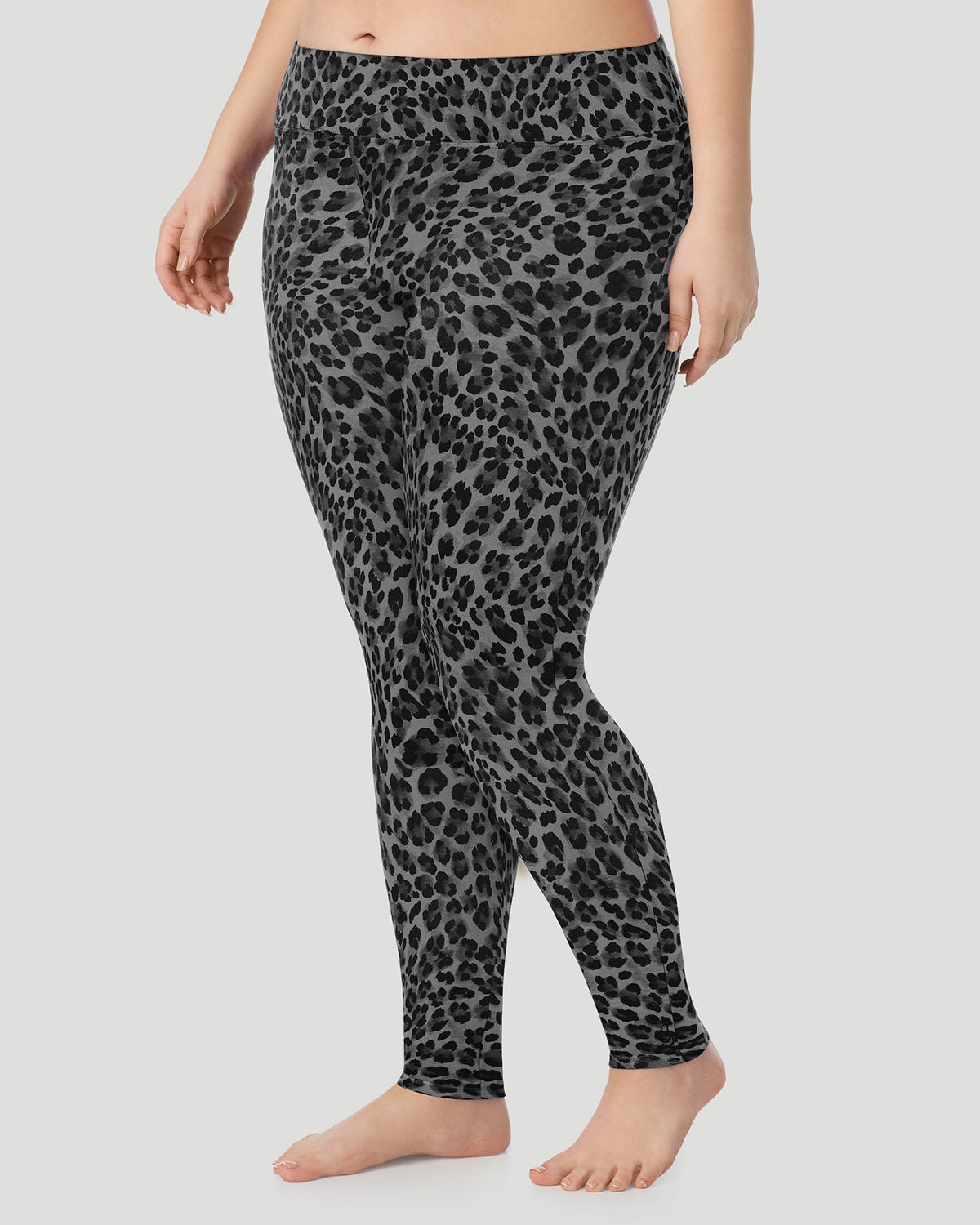 Charcoal Leopard; Model is wearing size 1X. She is 5'10", Bust 44", Waist 36", Hips 49". @A plus size lady wearing Softwear With Stretch High Waist Legging PLUS in charcoal leopard in a front view side angle pose