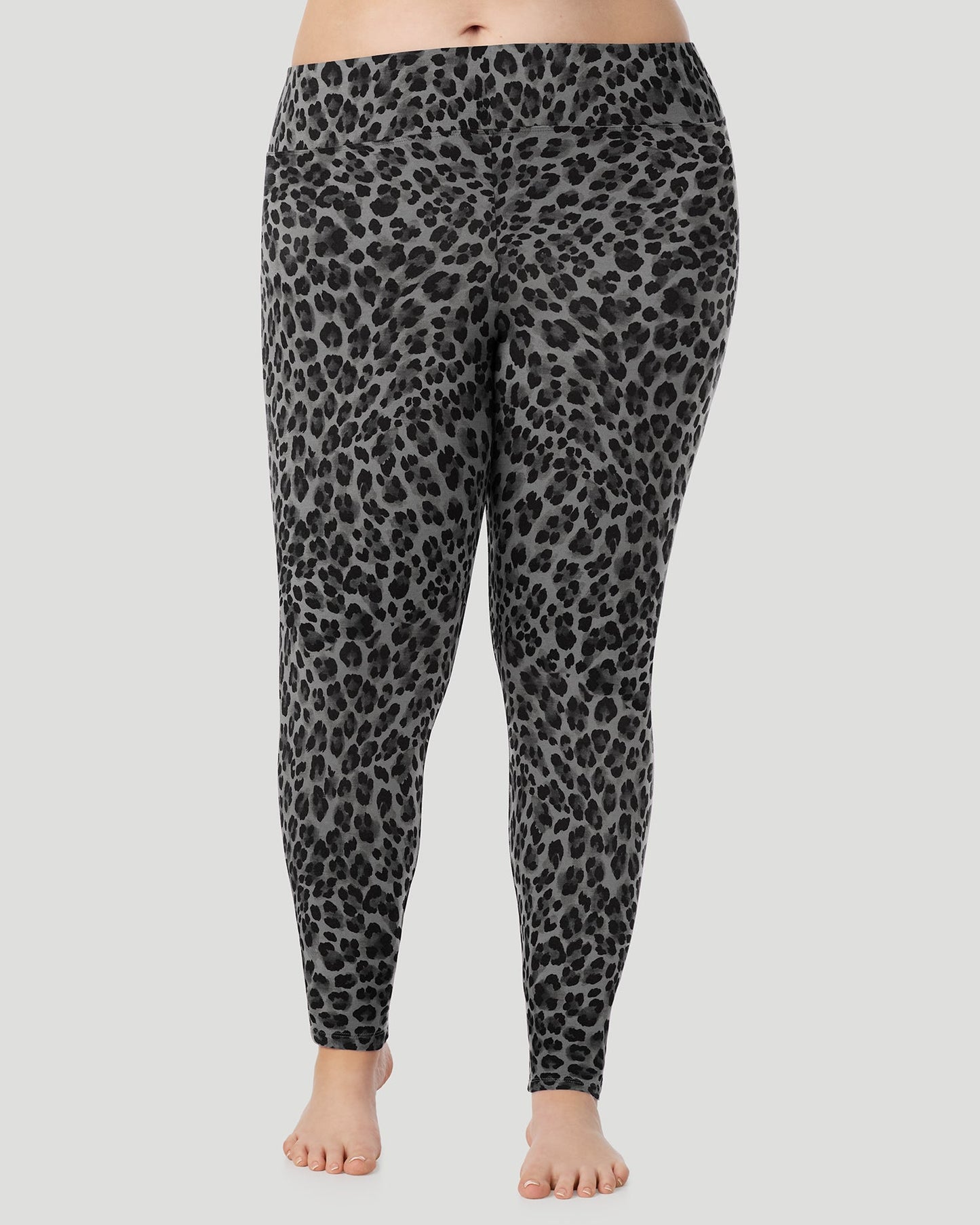 Charcoal Leopard; Model is wearing size 1X. She is 5'10", Bust 44", Waist 36", Hips 49". @A plus size lady wearing Softwear With Stretch High Waist Legging PLUS in charcoal leopard in a front view pose